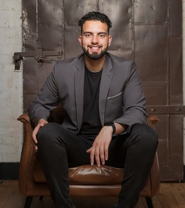 Adnan Han, Founder & CEO, PrivateDeals, seated in a leather armchair