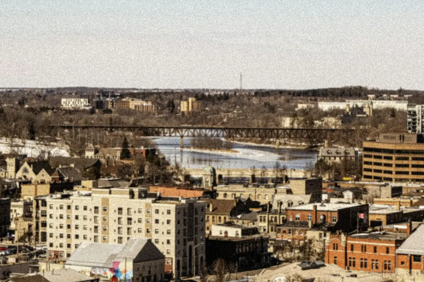 View over Galt rooftops toward the Grand River and the railway bridge in Cambridge, Ontario