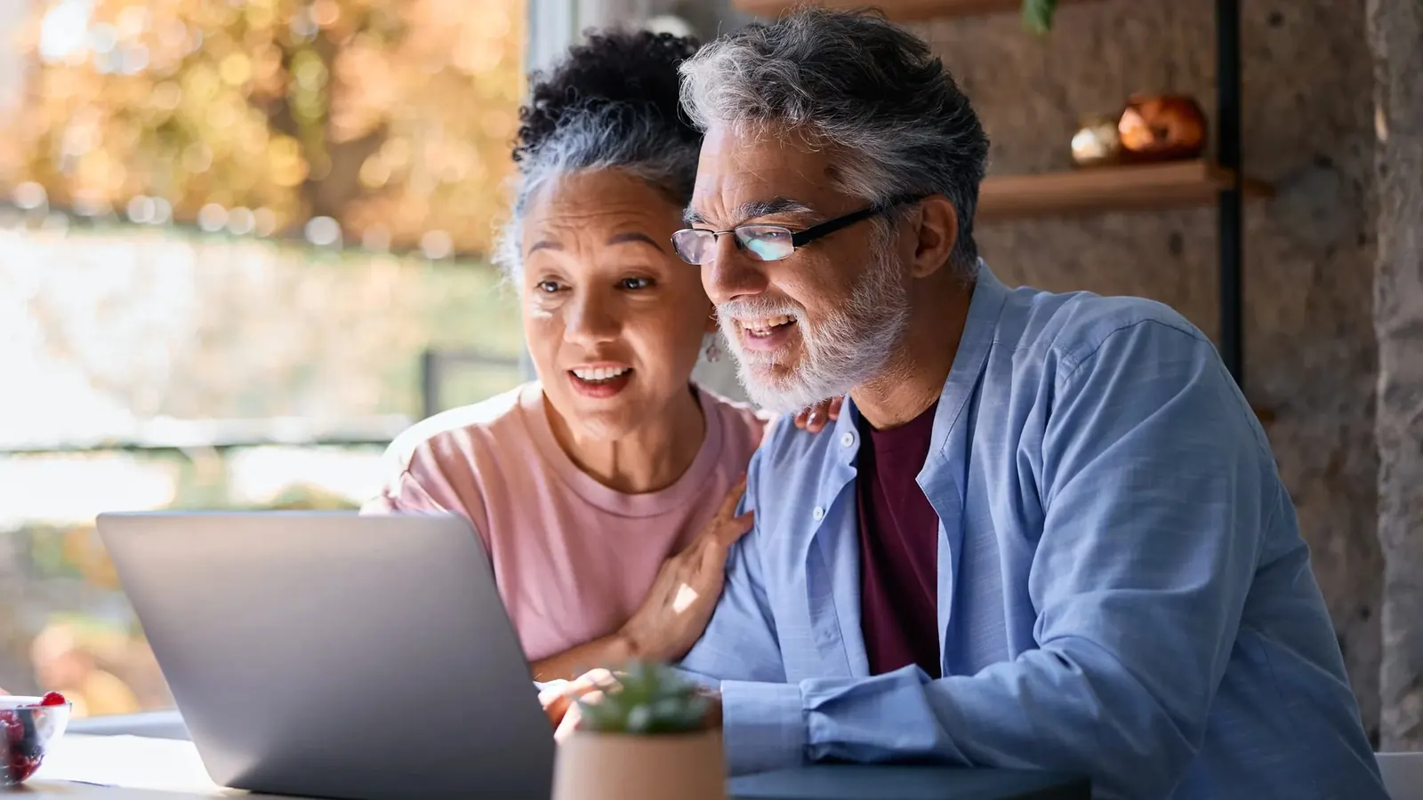 Couple reviewing a cash offer for their home on a laptop