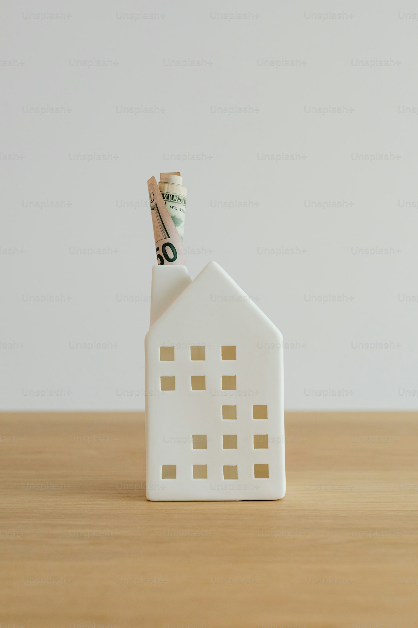 House shaped money holder representing a cash home sale in Ontario