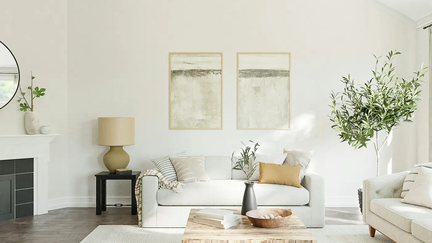 Bright staged living room with a white sofa, neutral decor and plants, ready for listing photos