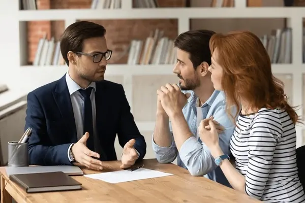 Homeowners telling a PrivateDeals home buyer about their house